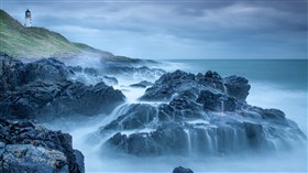 Lighthouse Overlooking the Rocks