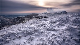 Sunset on a Snow Covered Mountain